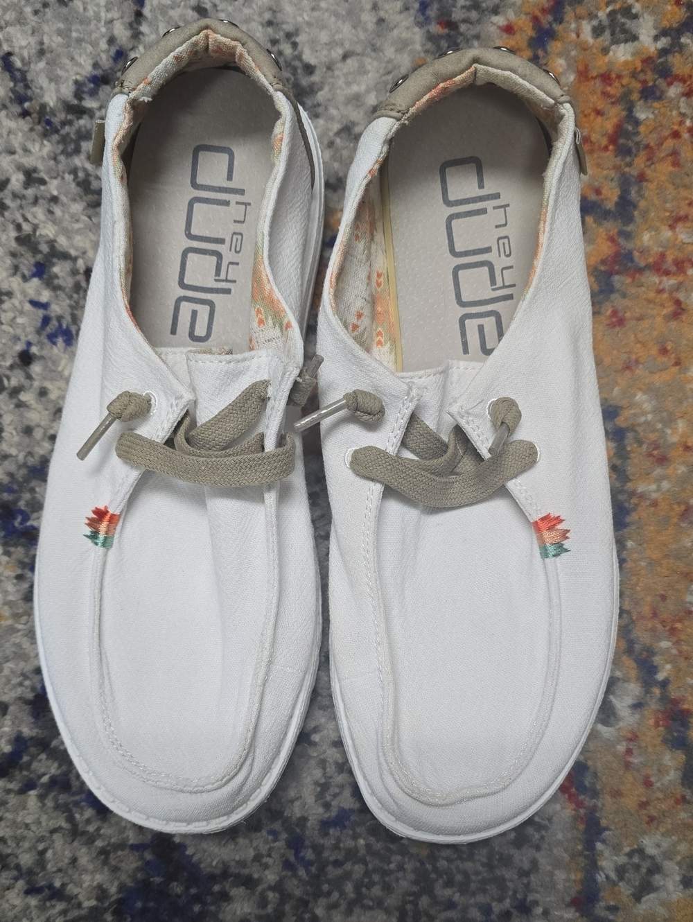 Hey Dude White Canvas Slip-On Sneakers with Tan Laces and Floral Accent